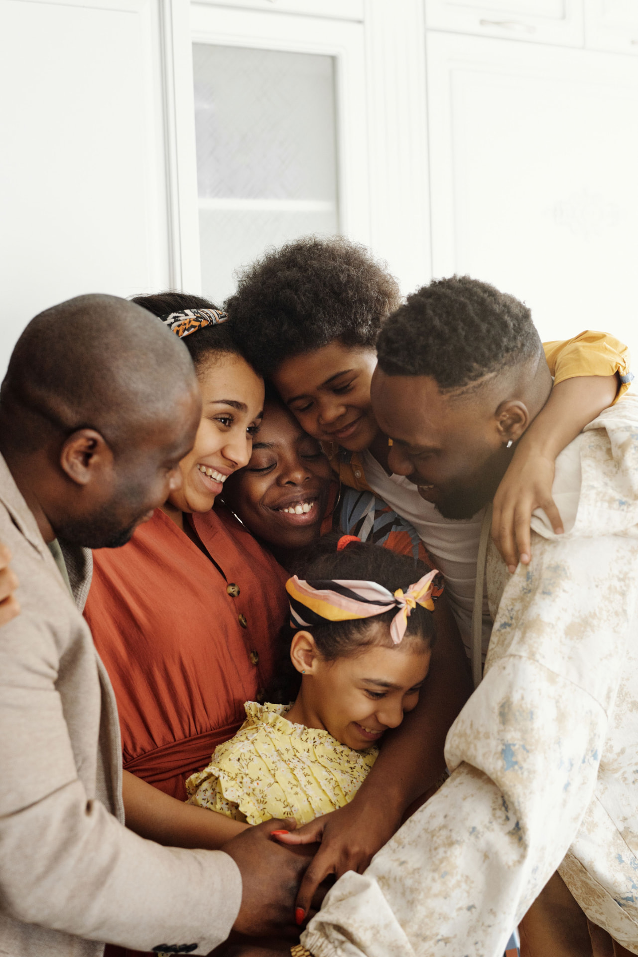 A joyful family sharing a warm group embrace